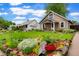 Charming home with a well-maintained lawn and garden beds at 4210 S Fox St, Englewood, CO 80110