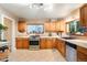 Traditional kitchen with wooden cabinets, tile floors, and lots of natural light at 4210 S Fox St, Englewood, CO 80110