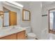 Bathroom featuring a sink, toilet, and a shower, providing a functional space with a vanity and mirror at 8911 W Yale Ave, Lakewood, CO 80227