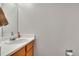 Bathroom with a sink and vanity with a wood finish at 8911 W Yale Ave, Lakewood, CO 80227