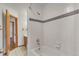 Clean bathroom featuring a shower over the tub, tiled walls, and a neutral color scheme, promoting a serene environment at 8911 W Yale Ave, Lakewood, CO 80227