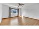 Bright bedroom featuring wood floors, a ceiling fan, and a window with views of the outside, creating a relaxing atmosphere at 8911 W Yale Ave, Lakewood, CO 80227