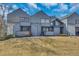 Inviting townhouse featuring a well-manicured lawn and stylish architectural details at 8911 W Yale Ave, Lakewood, CO 80227