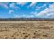 A scenic field with trees, mountains and blue skies in the background at 8911 W Yale Ave, Lakewood, CO 80227