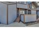 Charming entryway with a secure gate, wooden steps, and a cozy porch area at 8911 W Yale Ave, Lakewood, CO 80227