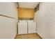 Basement laundry room featuring washer, dryer, pegboard wall, and linoleum flooring at 8911 W Yale Ave, Lakewood, CO 80227