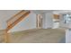 Spacious living room with carpet flooring and a stairway to the upper level at 8911 W Yale Ave, Lakewood, CO 80227