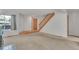 Spacious living room showcasing neutral carpet and staircase to upper level at 8911 W Yale Ave, Lakewood, CO 80227