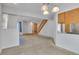 Bright living room with neutral carpet, access to the front door, and stairs leading to the upper level at 8911 W Yale Ave, Lakewood, CO 80227