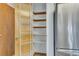 Pantry with shelving next to a stainless steel refrigerator at 8911 W Yale Ave, Lakewood, CO 80227