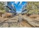 Street view of townhomes featuring garages and trees at 8911 W Yale Ave, Lakewood, CO 80227