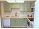 Renovated kitchen with white appliances and light green cabinets at 13890 E Marina Dr # 612, Aurora, CO 80014