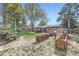 Lush backyard with mature trees, raised garden beds, patio, and shade canopy at 7080 Beach St, Westminster, CO 80030