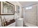 Cozy bathroom with white tiles, modern vanity, and stylish framed artwork at 7080 Beach St, Westminster, CO 80030