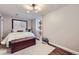 Comfortable bedroom with hardwood floors, ample natural light, and a charming decorative trunk at 7080 Beach St, Westminster, CO 80030