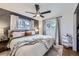 Cozy bedroom featuring a ceiling fan, bright windows, and a soothing color palette for relaxation at 7080 Beach St, Westminster, CO 80030