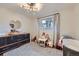 Brightly lit Bedroom with charming decor, including a dresser, toys, and a cozy crib for baby at 7080 Beach St, Westminster, CO 80030