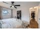 Bright bedroom with a ceiling fan, closet with organized clothes, and an open doorway to the hallway at 7080 Beach St, Westminster, CO 80030