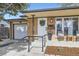 Close-up of the brick home's entrance, showcasing a stylish door, curated greenery, and a covered porch at 7080 Beach St, Westminster, CO 80030
