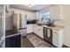 Modern kitchen with stainless steel appliances, white cabinets, and ample counter space at 7080 Beach St, Westminster, CO 80030