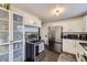 Functional kitchen with stainless steel appliances, built-in storage, and tile flooring at 7080 Beach St, Westminster, CO 80030