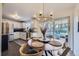 Eat-in kitchen featuring a round dining table, modern light fixture, and stainless steel appliances at 7080 Beach St, Westminster, CO 80030