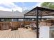 Backyard deck featuring a covered seating area with wood flooring and wood fence at 23 S Nome St # A, Aurora, CO 80012