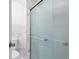 Bathroom featuring a textured glass shower door and marble-look tile at 23 S Nome St # A, Aurora, CO 80012