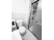 A clean bathroom featuring a toilet, shower, storage and marble design walls and flooring at 23 S Nome St # A, Aurora, CO 80012