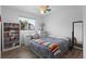 Bedroom featuring a double bed, large window, and built in bookcase at 23 S Nome St # A, Aurora, CO 80012
