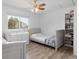 Cozy bedroom with natural light, featuring dual dressers and a closet at 23 S Nome St # A, Aurora, CO 80012