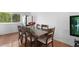 Dining room with a wooden table, seating for eight, and a window view at 23 S Nome St # A, Aurora, CO 80012