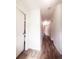 Long hallway with wood flooring, white doors, and neutral walls, creating a seamless flow throughout the home at 23 S Nome St # A, Aurora, CO 80012