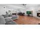 A open concept living room with kitchen, dining, fireplace and hardwood floors at 23 S Nome St # A, Aurora, CO 80012