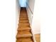 Staircase with natural-colored wood steps and white risers leading upstairs at 23 S Nome St # A, Aurora, CO 80012