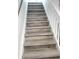 Close-up on stairs with wood-look treads and white risers and stringers showing the quality craftsmanship at 23 S Nome St # A, Aurora, CO 80012