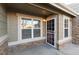 Front entry with stone accents and a screen door at 22100 E Jamison Pl, Aurora, CO 80016