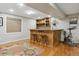 Finished basement with a custom bar, hardwood floors, and space for recreation and fitness equipment at 10155 Riverstone Dr, Parker, CO 80134
