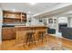 Finished basement features a wooden bar with barstool seating and adjacent entertainment area with a fireplace at 10155 Riverstone Dr, Parker, CO 80134