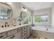 Luxurious bathroom with double sinks, modern fixtures, and a separate tub for a spa-like experience at 10155 Riverstone Dr, Parker, CO 80134