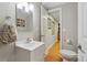 Well-lit bathroom includes a vanity with mirror and a toilet with an attached bright hallway at 10155 Riverstone Dr, Parker, CO 80134