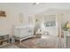 Charming Bedroom with a white crib, soft rug, and soothing decor for a peaceful environment at 10155 Riverstone Dr, Parker, CO 80134