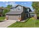 Charming two-story home featuring a well-manicured lawn, attached garage, and inviting curb appeal in a suburban setting at 10155 Riverstone Dr, Parker, CO 80134