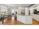 Open kitchen featuring white cabinetry, granite countertops, stainless steel appliances, and hardwood floors with adjacent dining area at 10155 Riverstone Dr, Parker, CO 80134