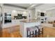 Modern kitchen featuring a center island, stainless appliances, granite counters, and an open layout with views to living spaces at 10155 Riverstone Dr, Parker, CO 80134