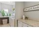 Bright laundry room with modern appliances, granite countertops, and stylish storage solutions at 10155 Riverstone Dr, Parker, CO 80134