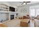 Comfortable living room featuring a fireplace, built-in shelving, and neutral tones, creating a warm and inviting atmosphere at 10155 Riverstone Dr, Parker, CO 80134