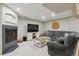 Comfortable living room area with fireplace and large screen TV, perfect for relaxing or entertaining guests at 10155 Riverstone Dr, Parker, CO 80134