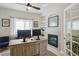 Well-lit home office with a fireplace, built-in shelves, and a large wooden desk perfect for a productive workspace at 10155 Riverstone Dr, Parker, CO 80134