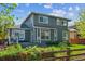 Back of house with a large outdoor patio area and lush greenery with privacy fence at 10155 Riverstone Dr, Parker, CO 80134